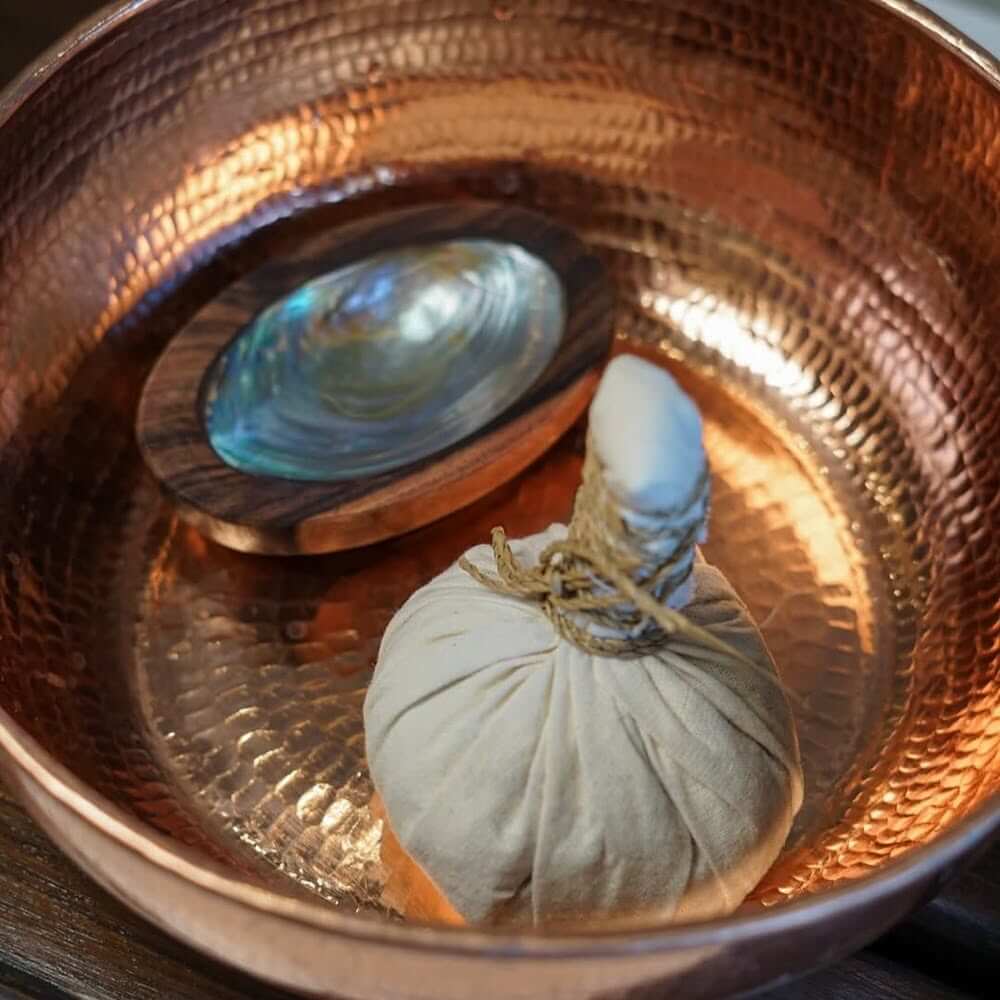 Application of mineral rich clay during a Hydrating Clay Head Spa Bali ritual