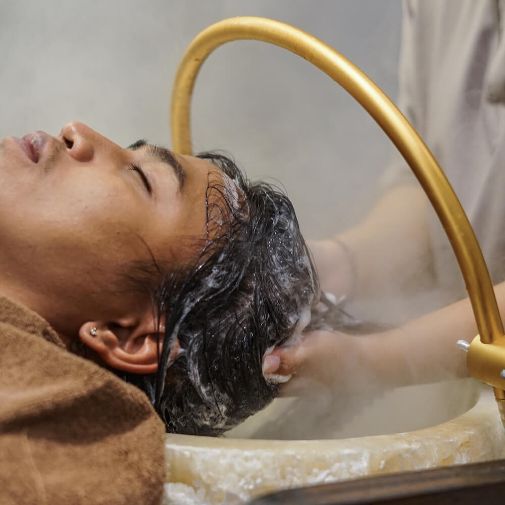 Signature hair wash and dry ritual using botanical cleansers in Bali